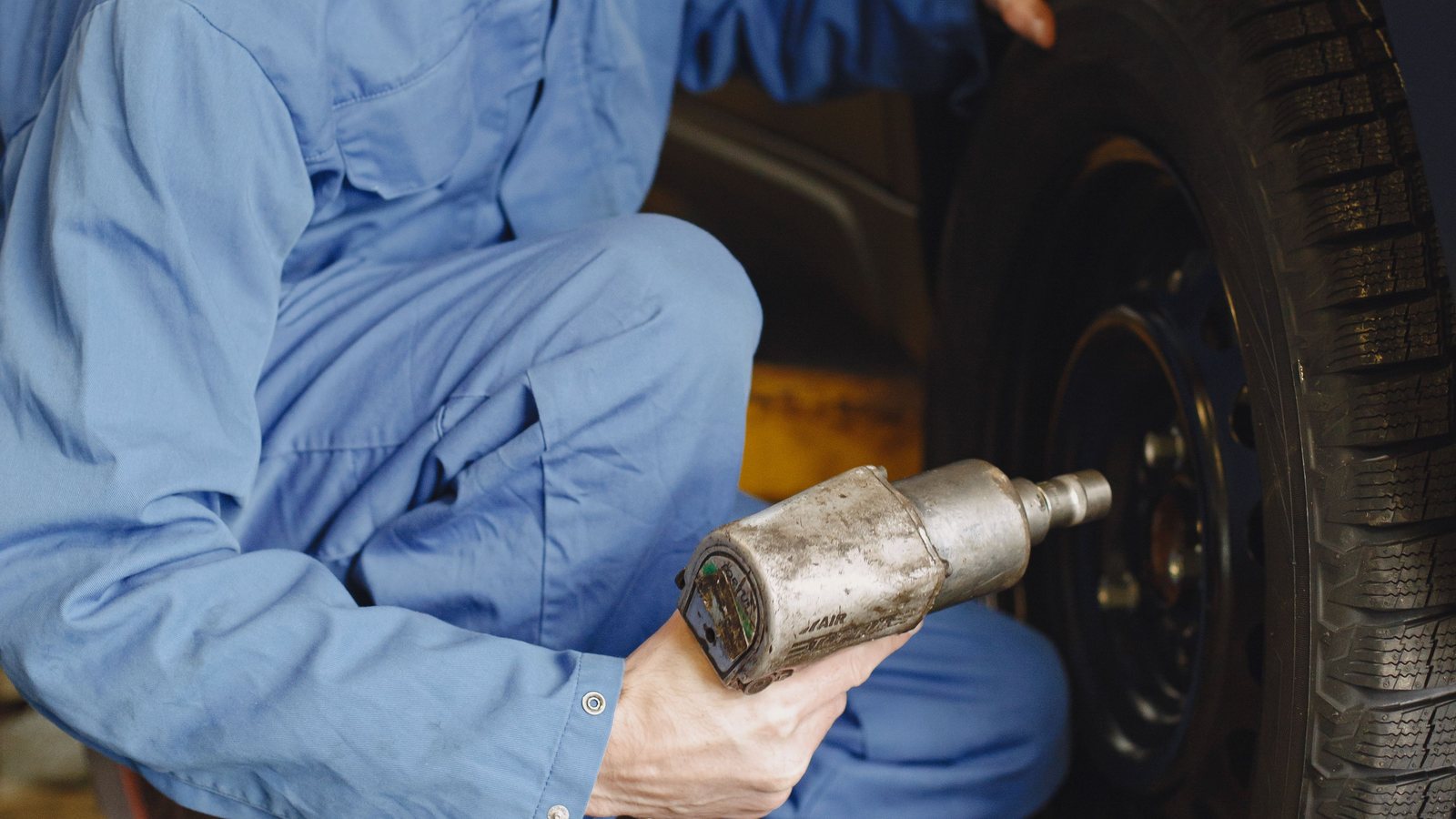 Technician servicing a vehicle tire for tire repair in Apopka FL